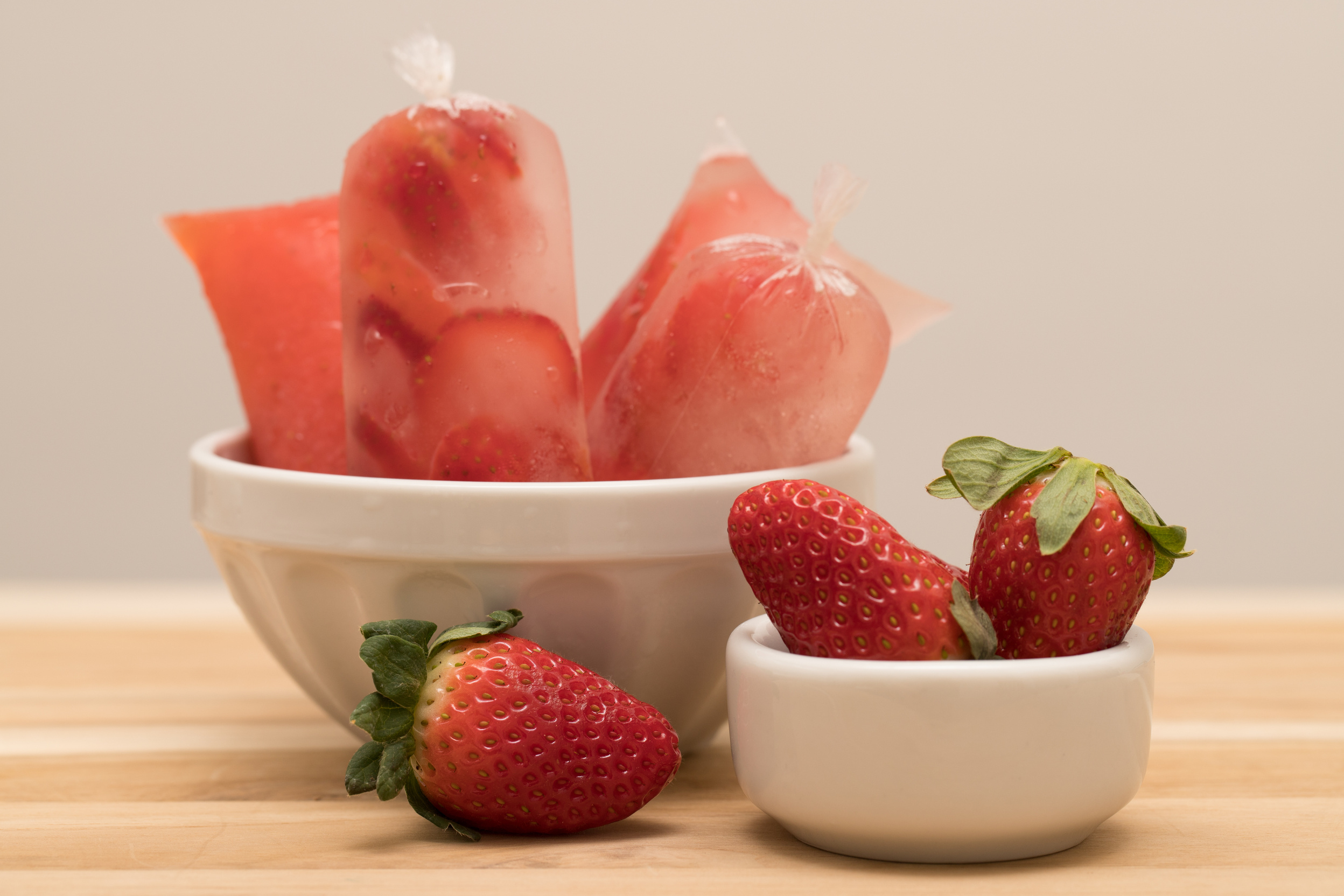 Fit strawberry Popsicle stick made with coconut water (brazilian chupchup/ chup chup / geladinho dindim). Strawberry. Selective focus.